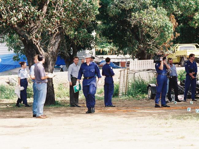 Police officers investigate the scene of a shoot-out between bikies in 1997.