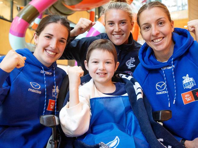 MELBOURNE, SEPTEMBER 7, 2023: Imogen Mulgrew meets Kangaroos forward Bella Eddey, Carlton midfielder Abbie McKay and Kangaroos forward Emma King at the RCH ahead of Sunday's AFLW SuperClash. Picture: Mark Stewart