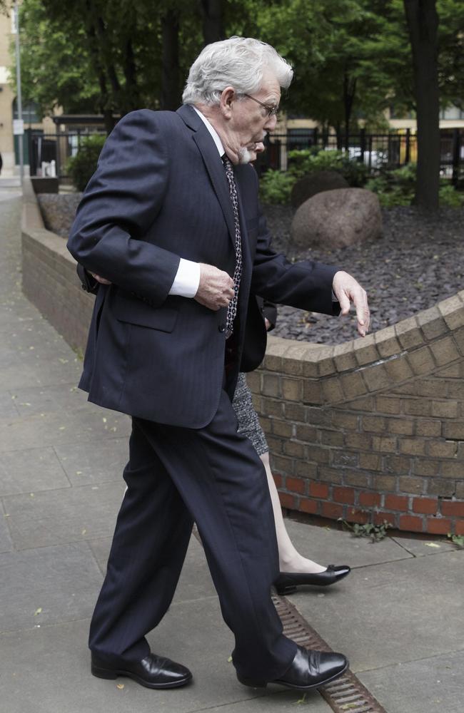Rolf Harris stumbles as he arrives at Southwark Crown Court today. Picture: AP/Tim Ireland