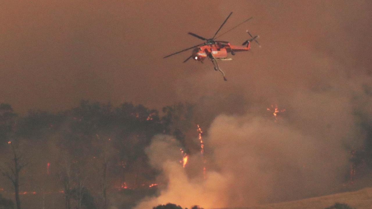 A chopper fights the fire outside Bruthen, with Gippsland on the highest alert as multiple fires burn in the area. Picture: David Crosling