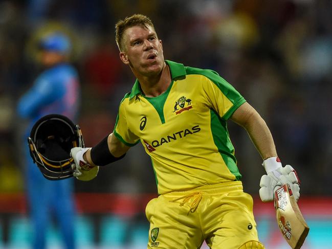 Australia's David Warner celebrates after scoring a century (100 runs) during the first one day international (ODI) cricket match of a three-match series between India and Australia at the Wankhede Stadium in Mumbai on January 14, 2020. (Photo by Punit PARANJPE / AFP) / IMAGE RESTRICTED TO EDITORIAL USE - STRICTLY NO COMMERCIAL USE