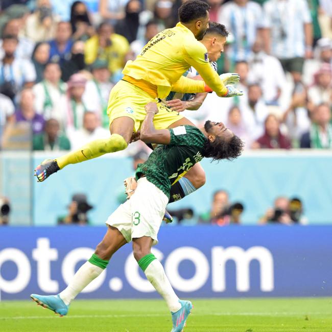 Saudi Arabia's goalkeeper Mohammed Al-Owais (L) collides with defender #13 Yasser Al-Shahrani (C).