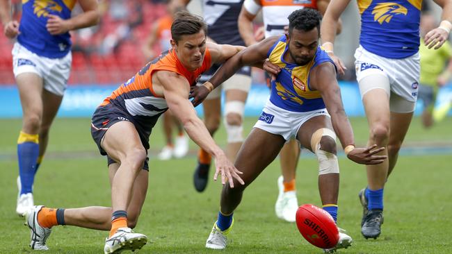 Giants debutant Isaac Cumming fights for the ball against West Coast’s Willie Rioli. Picture: AAP/Daniel Munoz.