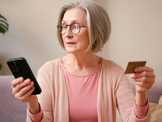 Credit card, online shopping and senior woman with phone on sofa ecommerce, payment or banking at home. Debit, fintech and grandmother with internet subscription, membership or budget in living room.