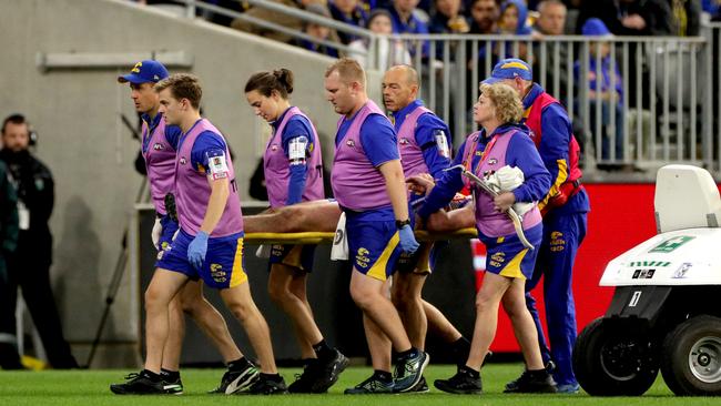 Daniel Venables is stretchered off the field by medics after a head collision. Picture: Richard Wainwright