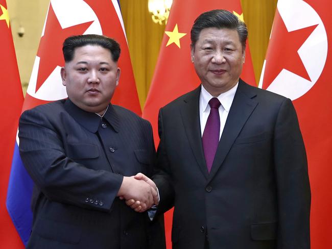 In this photo provided Wednesday, March 28, 2018, by China's Xinhua News Agency,  North Korean leader Kim Jong Un, left, and Chinese President Xi Jinping shake hands in Beijing, China. The Chinese government confirmed Wednesday that North Korea's reclusive leader Kim went to Beijing and met with Chinese President Xi in his first known trip to a foreign country since he took power in 2011. The official Xinhua News Agency said Kim made an unofficial visit to China from Sunday to Wednesday.(Ju Peng/Xinhua via AP)