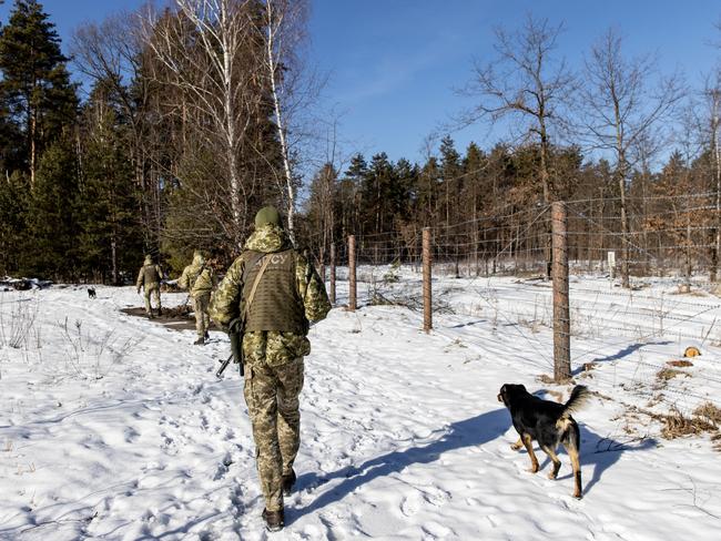 Members of the Ukrainian State Border Guard patrol along the border fence at the border crossing between Ukraine and Belarus. Picture: Getty Images