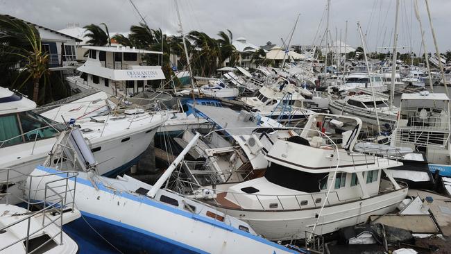 Damaged boats are stacked on top of one another at Port Hinchinbrook boat harbour in Cardwell, Thursday, February 3, 2011. (AAP Image/Dave Hunt)