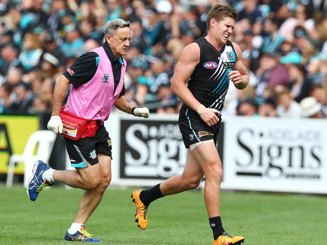 Matt White leaves the field in serious pain. Picture: Sarah Reed