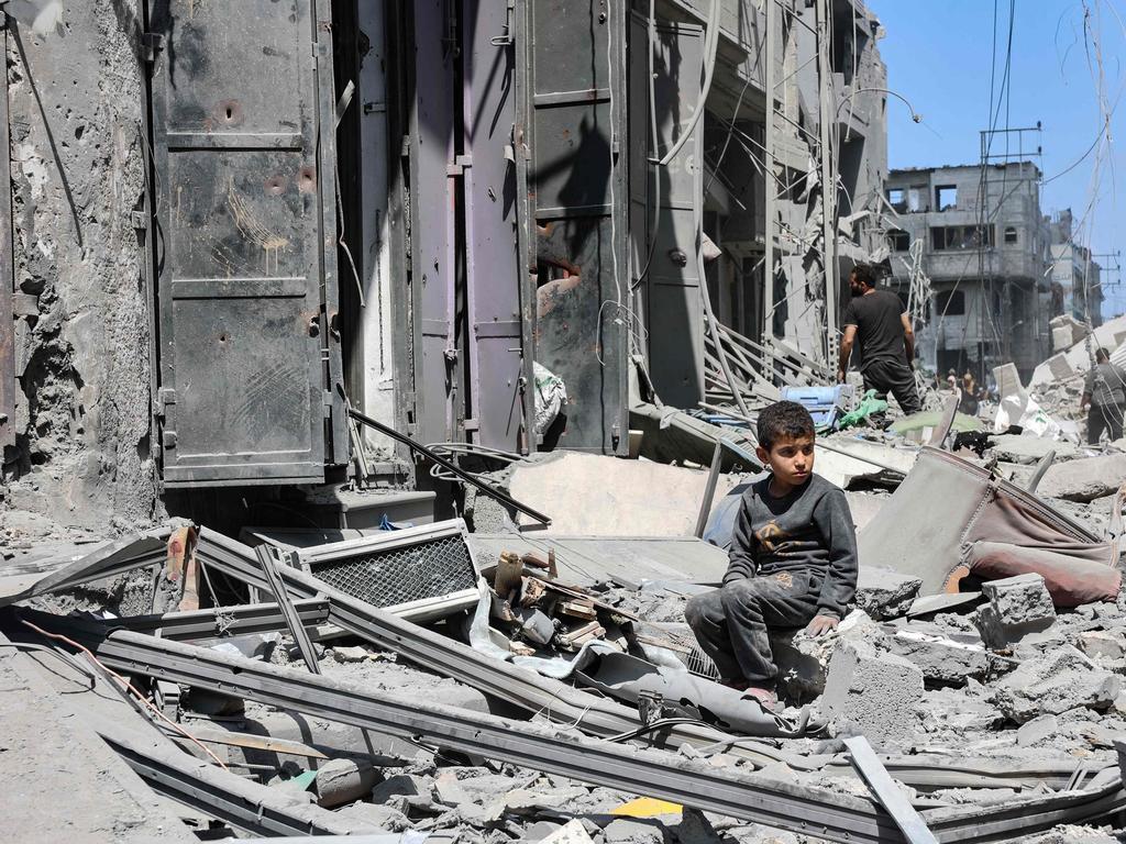 A young boy sits amid the debris of a building destroyed by Israeli bombardment in the al-Zaitoun neighbourhood of Gaza City.