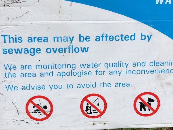 A Sydney Water sign warning of a sewage overflow has since been taken down.