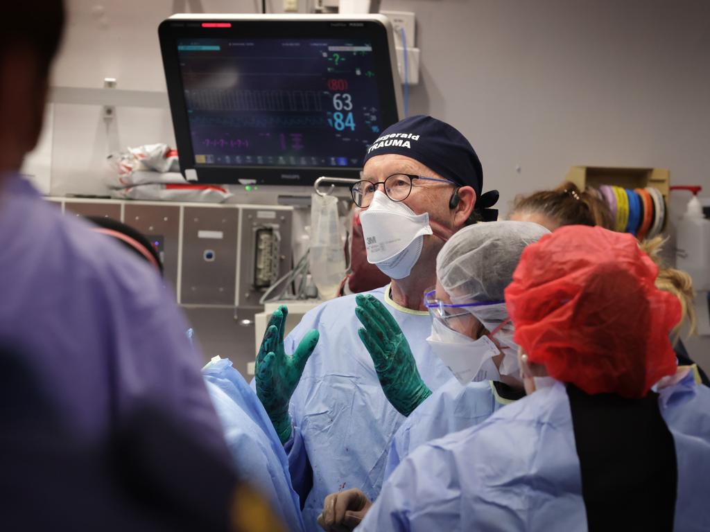 Professor Mark Fitzgerald talks with the team during the surgery. Picture: David Caird