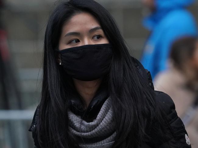 Many people are wearing masks (like this woman) since the outbreak of the Wuhan coronavirus. Picture: Timothy A Clary/AFP