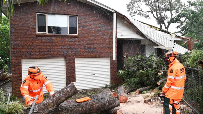 The clean up starts for hard hit Beerwah residents following Thursday morning’s severe thunderstorms. SES personal Dave Bethune and Andrew Kraut. Picture: Patrick Woods