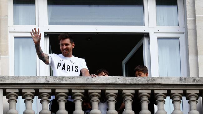 Lionel Messi waves at fans from a balcony of the Royal Monceau hotel in Paris. Picture: AFP