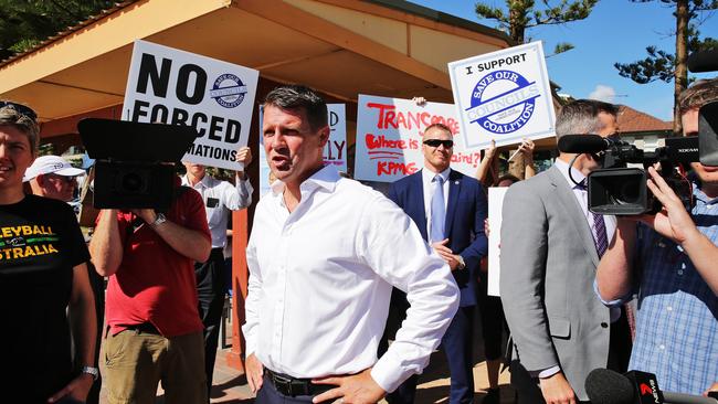 Premier Mike Baird faces protesters against council amalgamations at Manly Beach. Picture: Braden Fastier.