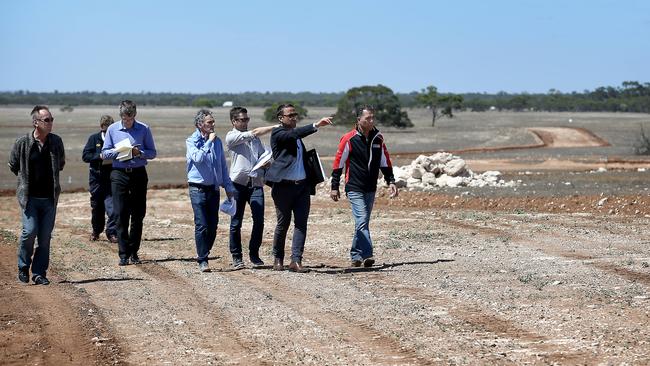 Sam Shahin shows motorsport officials around the under-construction motorsport park racetrack that Tailem Bend. Picture: Mike Burton