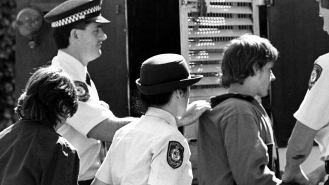 Wilmot escorted by police at Campbelltown Court in 1988.