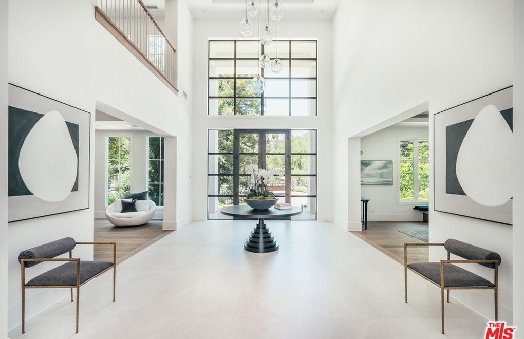 The entry hall with a double-height ceiling and a two-storey window wall. Picture: Realtor