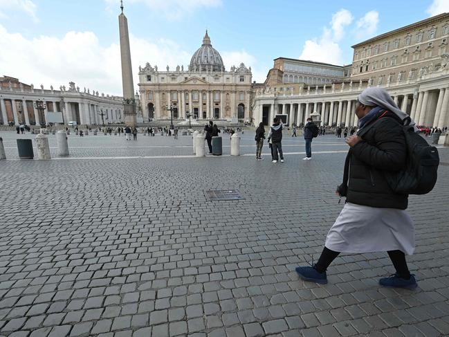 A nun walks on a deserted St. Peter's Square at the Vatican. Picture: AFP