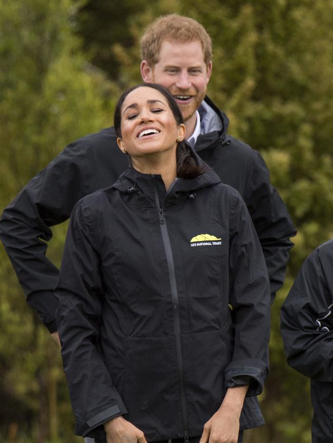 Meghan sees the light side during the  gumboot throwing competition in Auckland. Picture: AP