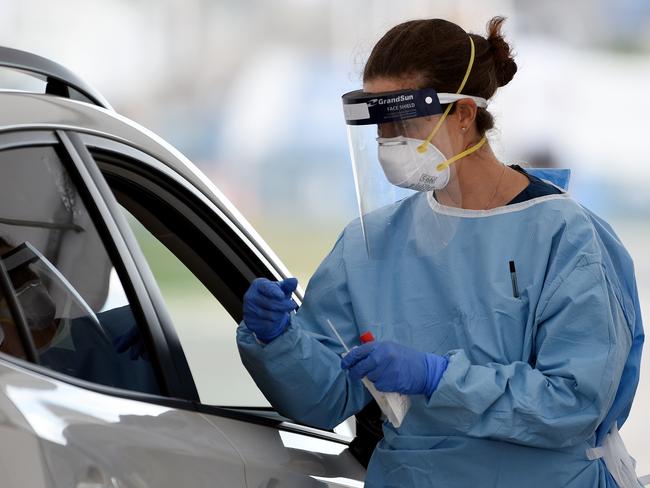 Medical professionals are seen performing COVID-19 tests on members of the public at the Bondi Beach drive-through COVID-19 testing centre in Sydney, Monday, April 6, 2020. Additional COVID-19 testing centres have been set up in Sydney's eastern suburbs of Waverley and Bondi, after a cluster of COVID-!9 outbreaks in the area, leading to a rise in community transmissions. (AAP Image/Bianca De Marchi) NO ARCHIVING