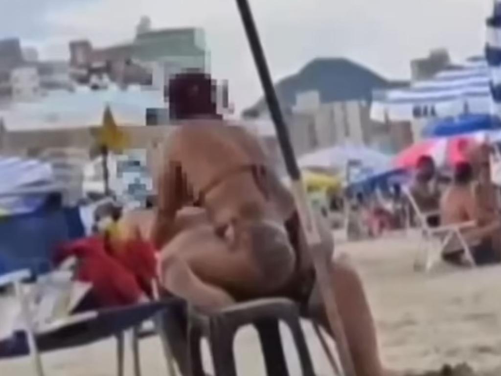 A couple’s make-out session on a beach was cut short when they were interrupted by a police officer, in footage that has since gone viral. Picture: G1