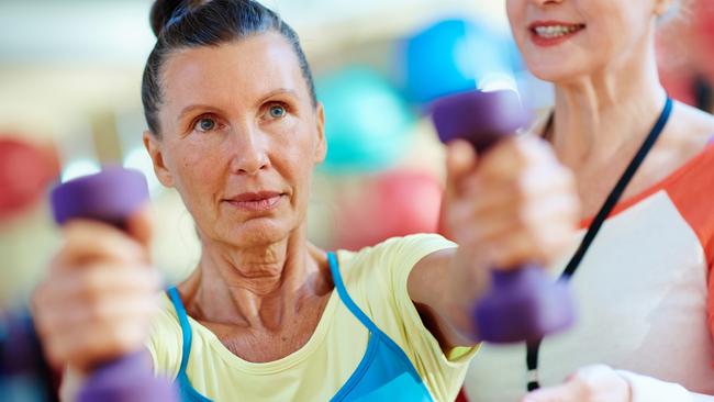 Warm-up of active senior woman in gym. Istock