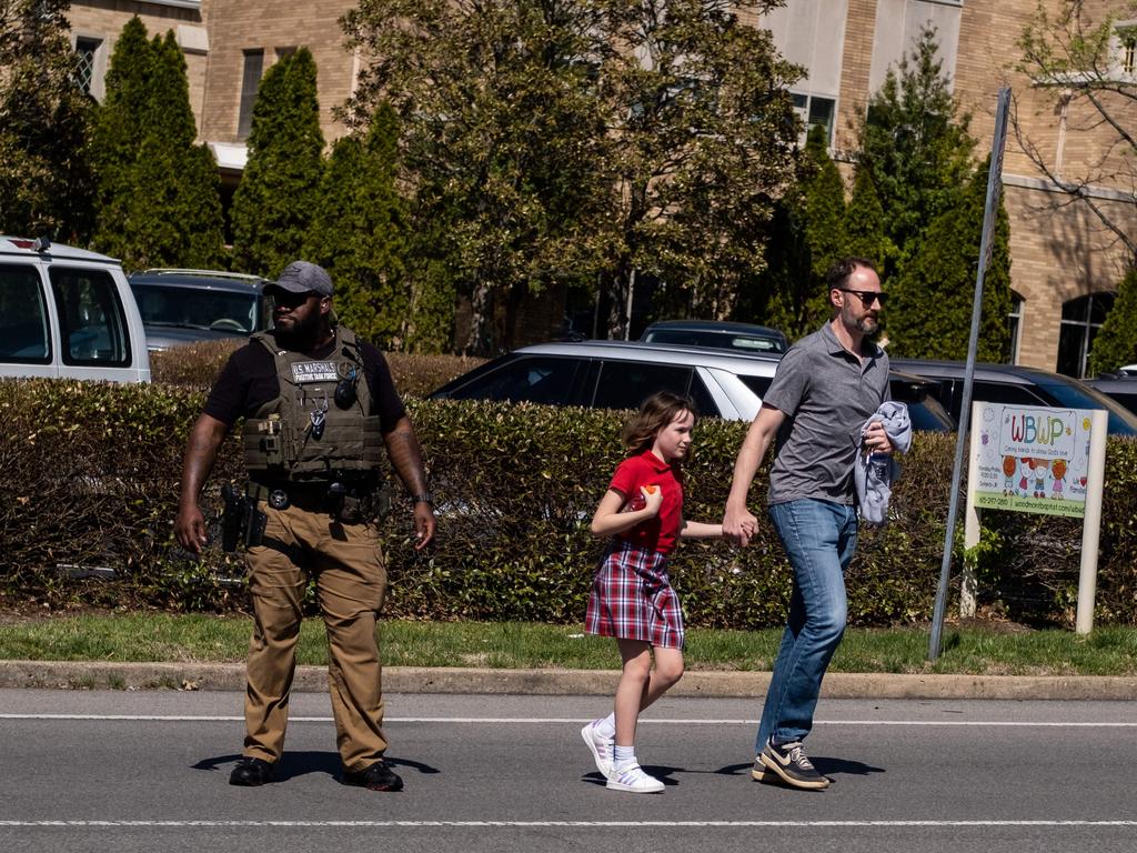 A child walks with her father after being rushed to safety. Picture: Seth Herald / Getty Images