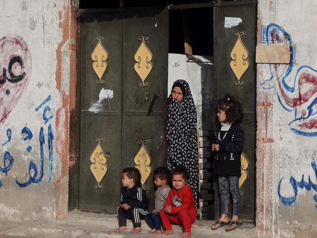 A Palestinian woman and children at their home during the funeral of twin babies killed in an overnight Israeli air strike in Rafah, southern Gaza. Picture: AFP