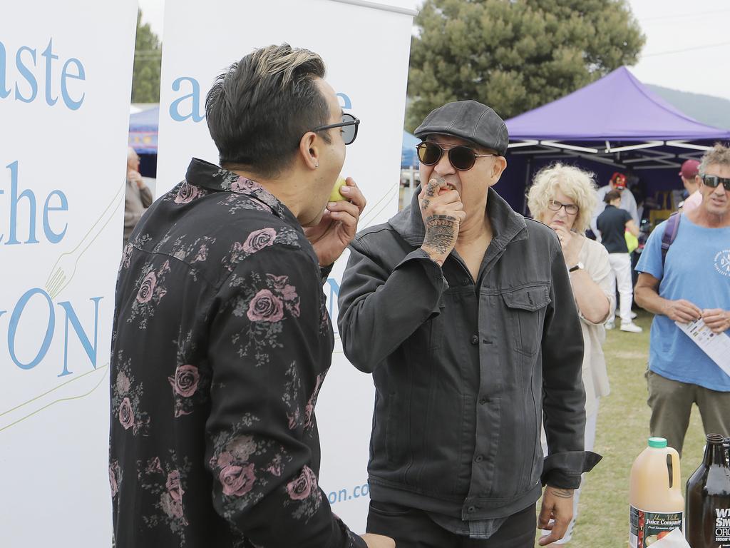 Rockers Jason Singh and Dale Ryder warm up on some Huon Valley apples before performing together on stage at the Taste of the Huon festival. Picture: MATHEW FARRELL