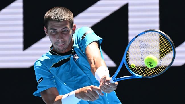 Alexei Popyrin plays a backhand in his round one singles match against Marc Polmans. Picture: Morgan Hancock/Getty Images