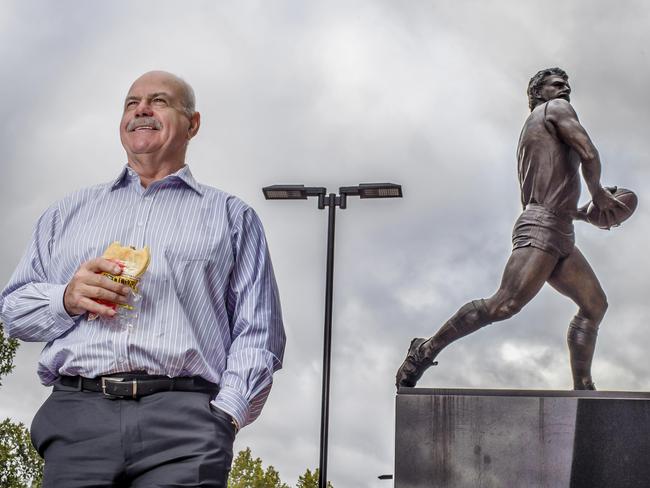 AFL Legend Leigh Matthews under his statue out the front of the MCG. Picture: Jason Edwards