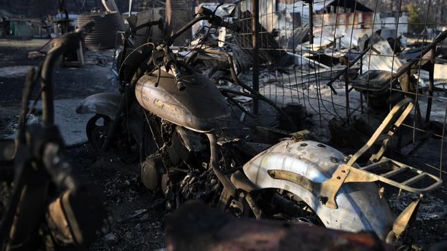 A burnt out motorcycle on a property destroyed by a bushfire in Torrington, near Glen Innes. Picture: AAP.