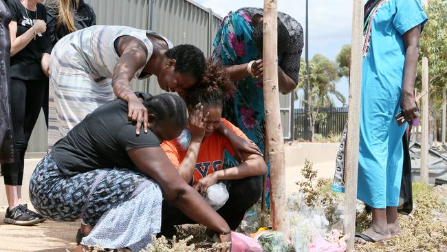 Friends and Family mourn the death of Bor Mabil and lay flowers at the site of the car crash which killed the young nursing student. Picture: Emma Brasier