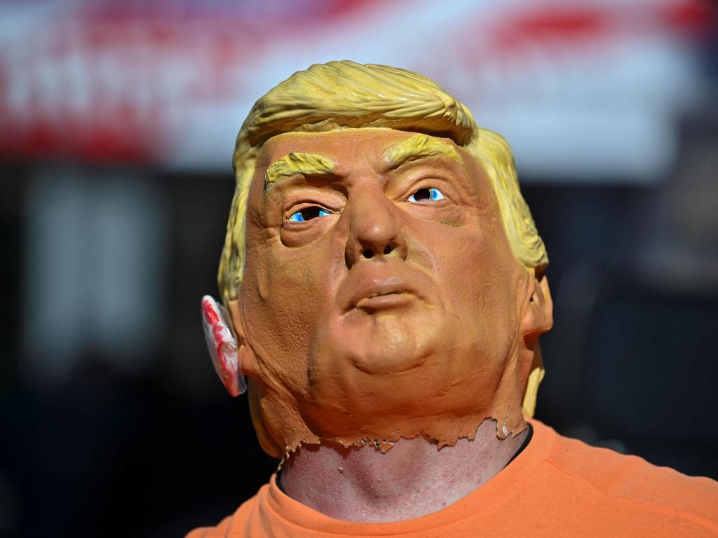 A masked Trump supporter lines up outside of the PPL Center ahead of Trump's campaign rally in Allentown, Pennsylvania. Picture: AFP