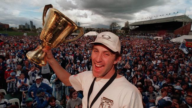 Corey McKernan celebrating the 1996 premiership in front of adoring fans at Arden Street.