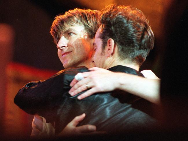 Neil Finn and Paul Hester hug at the end of the farewell concert on November 24, 1996. Picture: News Corp Australia