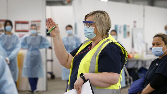 Site Lead Kylie Roper conducts a morning briefing to her staff. Picture: David Caird