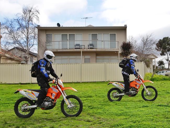 Police search on motorbikes pass behind the Ristevski's house. Picture: Hamish Blair