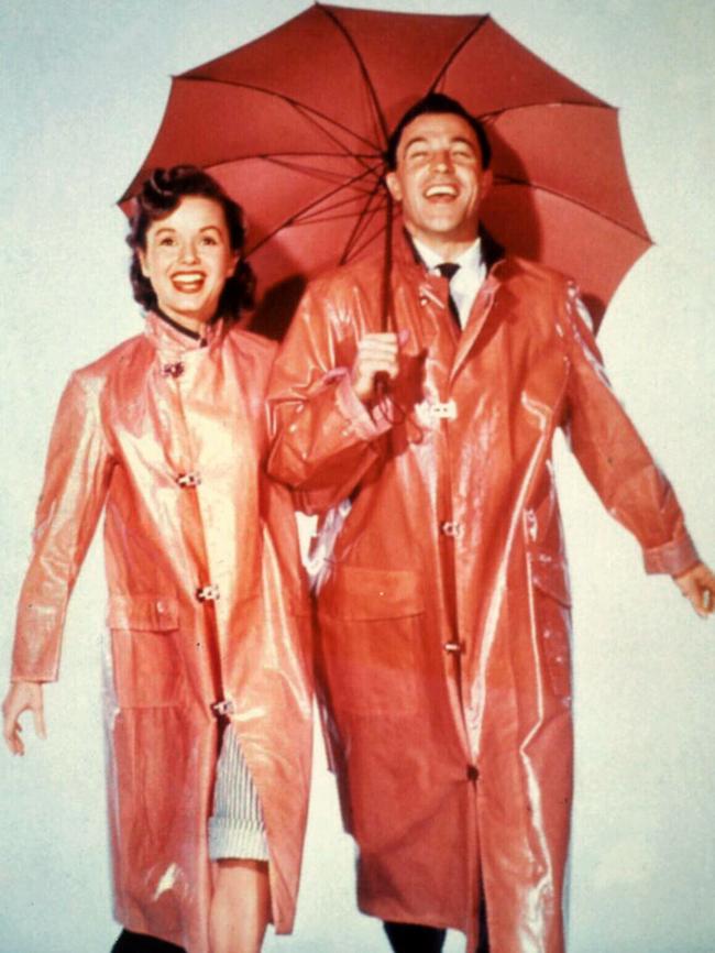 Actor Debbie Reynolds with Gene Kelly in scene from film “Singing in the Rain”.