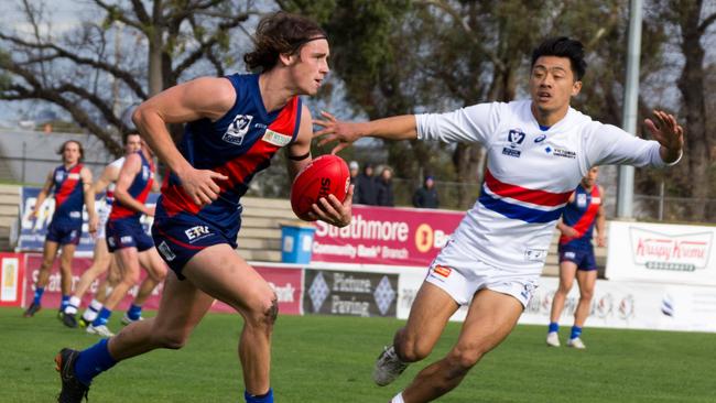 Coburg midfielder Marcus Lentini takes on Footscray's Lin Jong during a VFL game. Picture: Eleanor Armstrong