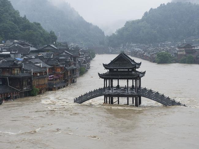 A bridge submerged in floodwaters in the ancient town of Fenghuang, central China's Hunan province.