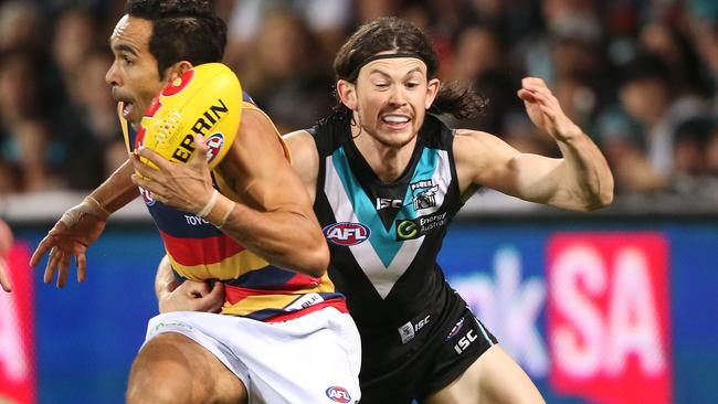 Eddie Betts breaks an attempted tackle from Jasper Pittard during his 250th AFL game. 2016. Pic: Ben McMahon/AAP