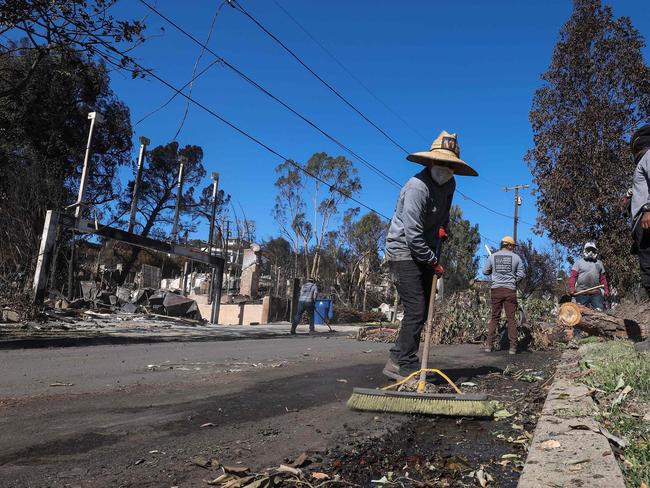 Residents are eager to start the clean up. Picture: AFP