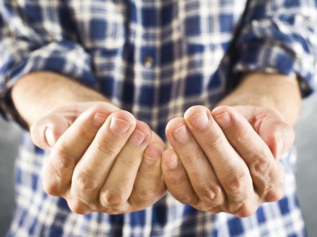 Male open hands for begging. Asking for money. Thinkstock