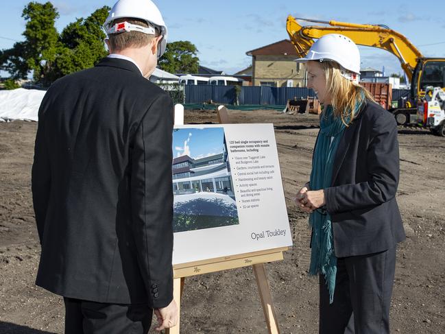 Opal Toukley Central Coast Mayor Jane Smith looks at the plans during the sod turning ceremony last week.