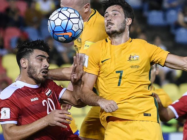 Khaled Almbayed of Syria (2L) and Mathew Leckie of Australia (C) fight for the ball during the 2018 World Cup qualifying football match between Syria and Australia at the Hang Jebat Stadium in Malacca on October 5, 2017. / AFP PHOTO / MOHD RASFAN