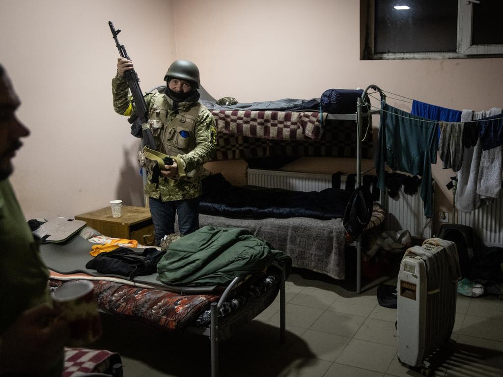 A member of a Territorial Defence unit prepares equipment before starting his shift guarding a barricade on the outskirts of eastern Kyiv. Picture: Chris McGrath/Getty Images