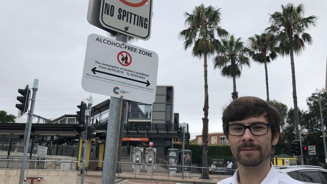 Ben Vorster outside the sign opposite Merrylands train station.